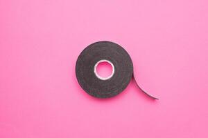 Reel of double-sided tape on a pink background, close-up, double-sided adhesive tape, element photo