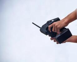 A man holds a radio-controlled remote in the hands of the car, competitions in radio-controlled models, toys, remote control, copy-space, controlled photo