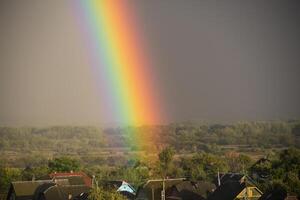 Part of a large rainbow over the private sector, close-up, a rainbow over a residential area of the city photo