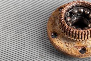 Old rusty wheel hub with a broken bearing. Bearing jamming. Automotive Part, close-up. Copy space for text photo