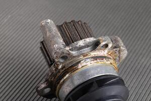 Old leaky car pump. Breakdown of the car pump in the cooling system, macro photo