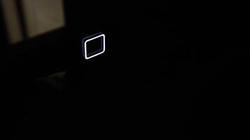 Modern bathroom mirror with light and touch button, close-up photo