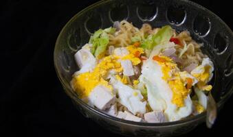 instant noodle soup with egg and tofu topping photo