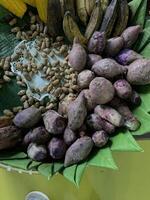 Traditional healthy snacks menu for parties in Indonesia, there are sweet corn, stewed peanuts, potatoes, bananas and breadfruit fresh from steamer. photo