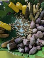 Traditional healthy snacks menu for parties in Indonesia, there are sweet corn, stewed peanuts, potatoes, bananas and breadfruit fresh from steamer. photo