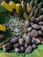 Traditional healthy snacks menu for parties in Indonesia, there are sweet corn, stewed peanuts, potatoes, bananas and breadfruit fresh from steamer. photo
