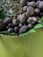 Traditional healthy snacks menu for parties in Indonesia, there are sweet corn, stewed peanuts, potatoes, bananas and breadfruit fresh from steamer. photo