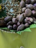 Traditional healthy snacks menu for parties in Indonesia, there are sweet corn, stewed peanuts, potatoes, bananas and breadfruit fresh from steamer. photo