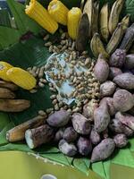Traditional healthy snacks menu for parties in Indonesia, there are sweet corn, stewed peanuts, potatoes, bananas and breadfruit fresh from steamer. photo