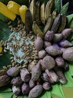 Traditional healthy snacks menu for parties in Indonesia, there are sweet corn, stewed peanuts, potatoes, bananas and breadfruit fresh from steamer. photo