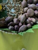 Traditional healthy snacks menu for parties in Indonesia, there are sweet corn, stewed peanuts, potatoes, bananas and breadfruit fresh from steamer. photo