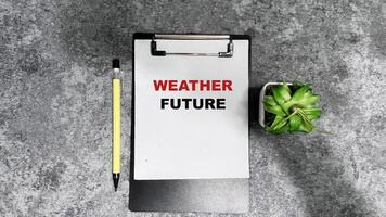 Concept of Weather Future write on paperwork isolated on Wooden Table. photo