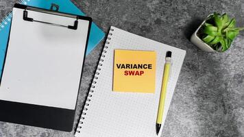Concept of Variance Swap write on sticky notes isolated on Wooden Table. photo
