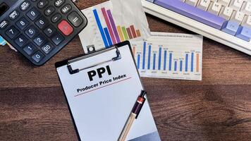 Concept of PPI - Producer Price Index write on paperwork isolated on Wooden Table. photo