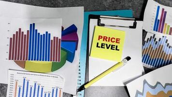 Concept of Price Level write on sticky notes isolated on Wooden Table. photo