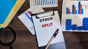 Concept of Stock Split write on paperwork isolated on Wooden Table. photo
