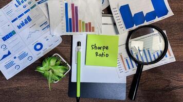 Concept of Sharpe Ratio write on sticky notes isolated on Wooden Table. photo