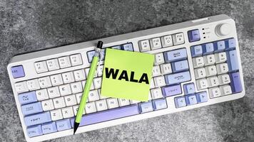 Concept of WALA write on sticky notes isolated on Wooden Table. photo