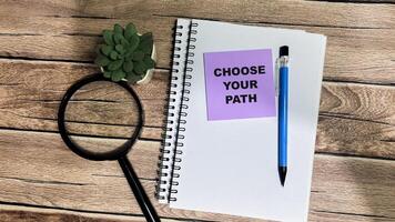 Concept of Choose Your Path write on sticky notes isolated on Wooden Table. photo