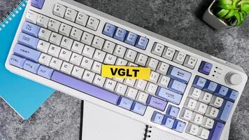 Concept of VGLT write on sticky notes isolated on Wooden Table. photo