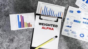 Concept of Weighted Alpha write on paperwork isolated on Wooden Table. photo
