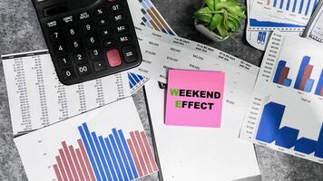 Concept of Weekend Effect write on sticky notes isolated on Wooden Table. photo