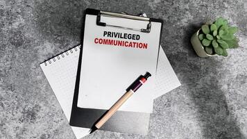 Concept of Privileged Communication write on paperwork isolated on Wooden Table. photo
