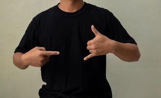 Young man showing CALL ME gesture in sign language photo