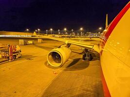 Night View of Airplane on Airport Tarmac with Engine and Lights. High quality photo