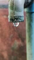 A close up of a water faucet with a drop of water video