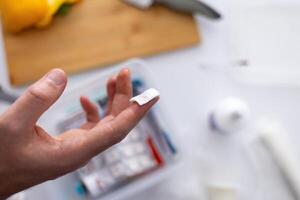 concept of first aid for cuts and injuries.a person holding a piece of paper with a pill photo