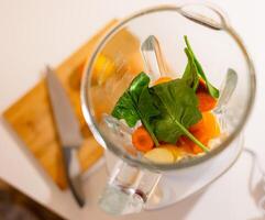 a blender with a bunch of vegetables in it, top view photo
