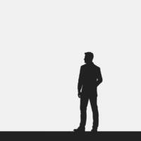 Silhouette of a man standing in front of a white background vector