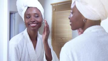 Black woman at home Body Love, Skin Care, Cosmetics in the mirror after shower. video