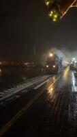 Gazing at wet street reflections shrouded in fog, illuminated by soft lights at night video