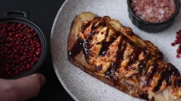 Grilled mackerel fillets with cheese, salt, spices and herbs on dark concrete background video
