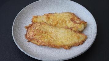 Grilled chicken or turkey chop with salt, spices and herbs on a dark concrete background video