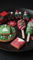 Natural popsicle ice cream on a stick covered with chocolate in the style and colors of Christmas and New Year on a dark concrete background video