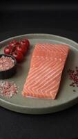 Fresh raw salmon steak with spices and herbs prepared for grilled baking. Healthy seafood food video