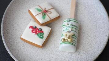 Natural popsicle ice cream on a stick covered with chocolate in the style and colors of Christmas and New Year on a dark concrete background video