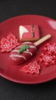 Natural popsicle ice cream on a stick covered with chocolate in the style and colors of Christmas and New Year on a dark concrete background video