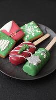 Natural popsicle ice cream on a stick covered with chocolate in the style and colors of Christmas and New Year on a dark concrete background video