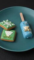 Natural popsicle ice cream on a stick covered with chocolate in the style and colors of Christmas and New Year on a dark concrete background video