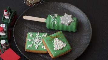 Natural popsicle ice cream on a stick covered with chocolate in the style and colors of Christmas and New Year on a dark concrete background video