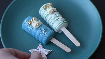 Natural popsicle ice cream on a stick covered with chocolate in the style and colors of Christmas and New Year on a dark concrete background video