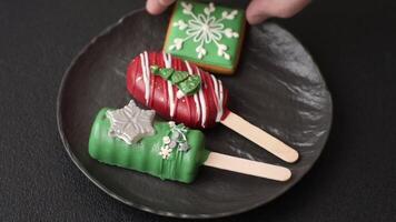 Natural popsicle ice cream on a stick covered with chocolate in the style and colors of Christmas and New Year on a dark concrete background video