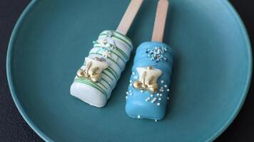 Natural popsicle ice cream on a stick covered with chocolate in the style and colors of Christmas and New Year on a dark concrete background video