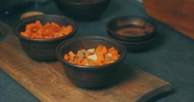Two small bowls filled with carrots on a wooden cutting board video