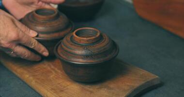 A person holding a wooden bowl with a lid on it video