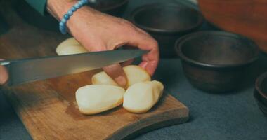 A person cutting up potatoes on a cutting board video